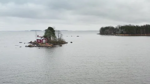 Secluded red cottage on tiny island as perfect introvert retreat Stock Footage 326124837