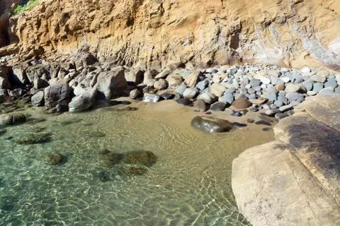 Secluded rocky beach Stock Photos