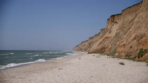 Secluded sand beach surrounded by cliffs. Sea expanse landscape. Stock Footage 170269626