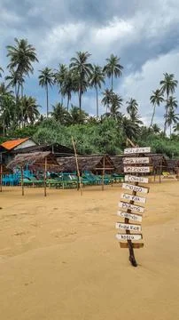 Secluded Tranquility: Thatched Beach Hut Overlooking Serene Tropical sea in.. Stock Photos