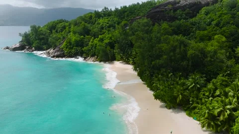 Secluded tropical beach with lush greenery and turquoise water. Seychelles, Mahe Stock Footage 303551608