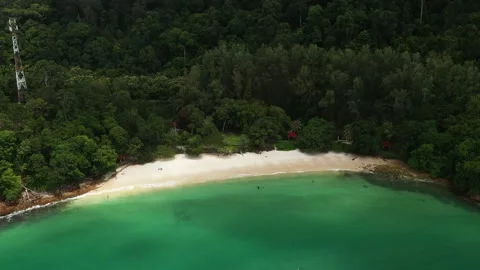 Secluded tropical skeleton beach with clear turquoise waters and lush green Stock Footage 319652355