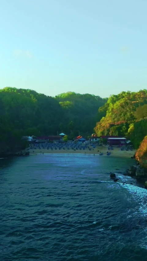 Secluded turquoise cove lies between forested cliffs along the rugged tropi.. Stock Footage 341547457