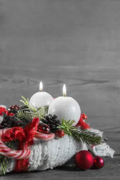 Second advent: two red burning candles on wooden shabby background. Stock Photos