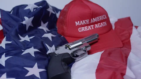 Second Amendment - American Gun laws rack focus to gun and MAGA hat Stock Footage 300747277