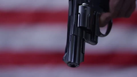 Second Amendment - Gun in front of american flag zoom out Stock Footage 300899689
