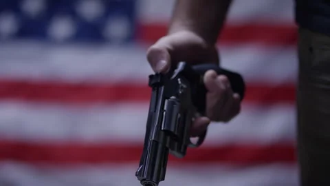 Second Amendment - Man holding gun on american flag Stock Footage 300806677