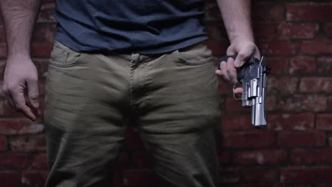 Second Amendment - Man seeking revenge with gun in front of wall Stock Footage 300899534