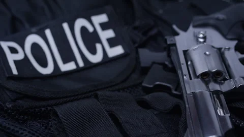 Second Amendment - Police gun and tactical vest spinning background Stock Footage 301035823