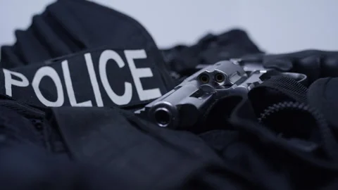 Second Amendment - Police vest and revolver hand gun Stock Footage 301019935