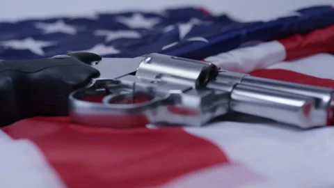 Second Amendment - Rotating hand gun on american flag Stock Footage 301041149