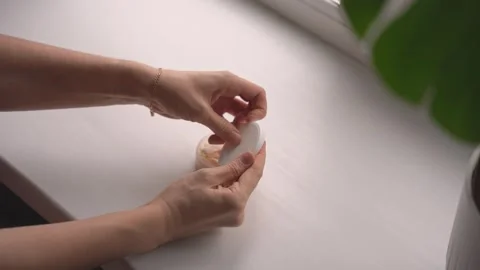 Second angle taking used pouch from lid compartment Stock Footage 320896996