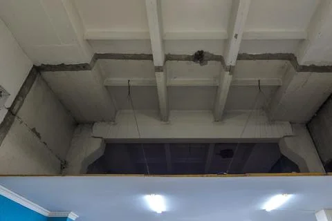 Second ceiling hanged with exposed steel wires indoors in industrial building Stock Photos