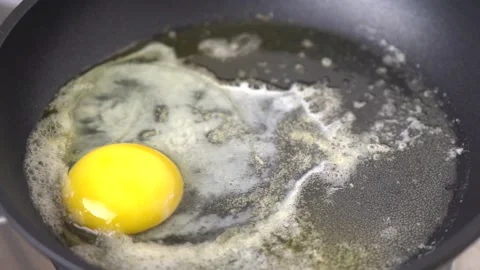 Second Chicken Egg Putting Into A  Black Frying Pan. Stock Footage 131149634