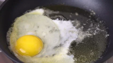 Second Chicken Egg Putting Into A  Black Frying Pan. Stock Footage 131149841