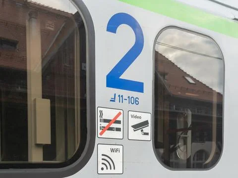 A second class sign on a train car with international icons for no smoking, Stock Photos