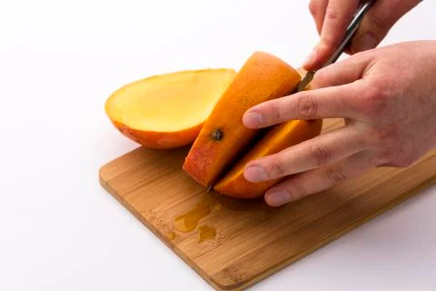 Second cut through a mango does yield three slices Stock Photos