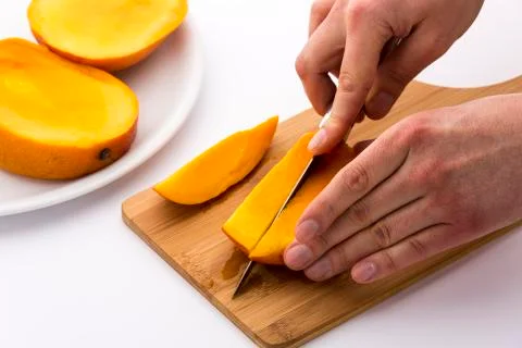 Second cut through one third of a trisected mango Stock Photos