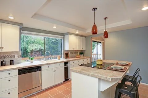 Second floor Kitchen boasts tray ceiling, island and white shaker cabinets. F Stock Photos