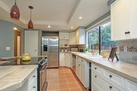 Second floor Kitchen boasts tray ceiling, island and white shaker cabinets. F Stock Photos