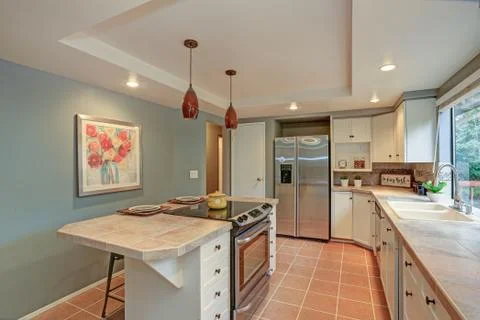 Second floor Kitchen boasts tray ceiling, island and white shaker cabinets. F Stock Photos