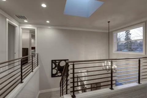 Second floor landing in gray tones features skylight over the staircase with met Stock Photos