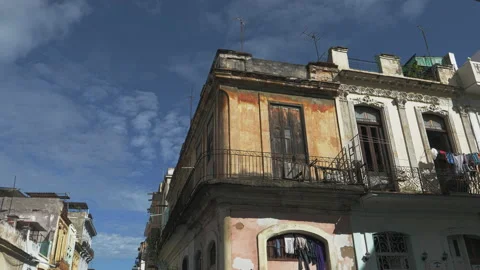 Second floor windows of an old building with balconies on a street corner Stock Footage 228861079