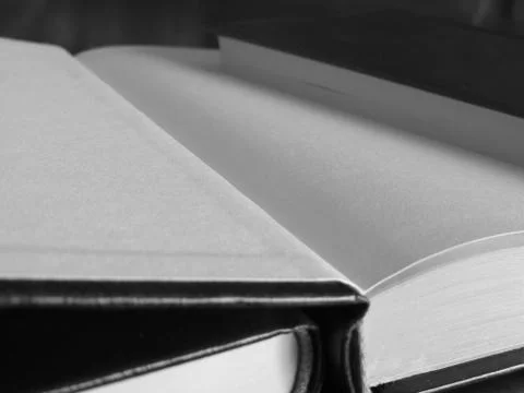 Second hand books with blank pages on a wooden table . Black and white photo Foto stock