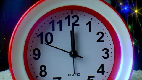 The second hand on the clock moves towards the number twelve. Bright multi Stock Footage 166104748