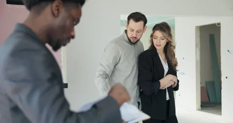 Second Home couple meets an agent to discuss purchasing a vacation property or Stock Footage 277679338