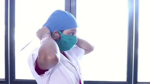 Second Wave Of Covid-19, Indian Female Doctor Or Nurse  Puts A Surgical Cap Stock Footage 130224691
