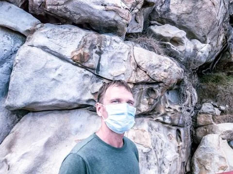 Second wave COVID 19. Young beautiful man in face mask under crisis problems Foto stock