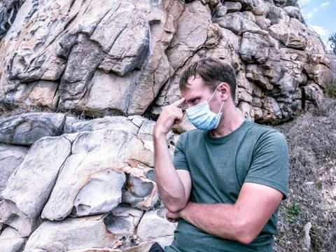 Second wave COVID 19. Young man in face mask under crisis problems, working Stock Photos