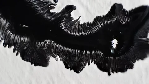 Second wave of feathered black ink radiates from original bloom on white paper Stock-Footage 308731146