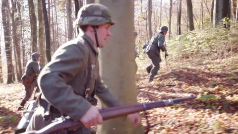 Second World War German soldiers run through forest 4K Stock Footage 149475838