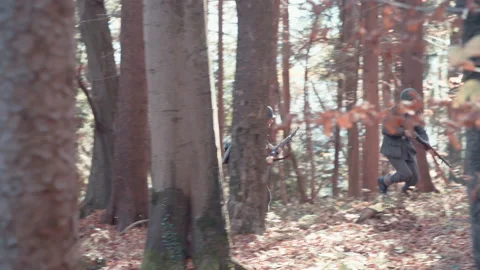 Second World War German soldiers run through forest 4K Stock Footage 149477215