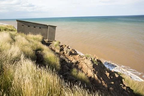 A Second world War lookout post leaning alarmingly and about to tumble over t Stock Photos