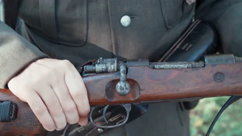 Second World War soldier check a rifle in bad condition 4K Stock Footage 149476357