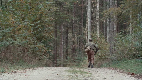 Second World War soldier run through forest long shot 4K Stock Footage 149472430