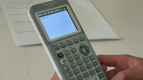Secondary School Student Solving A Math Problem Using The Classic TI-84 Plus CE Stock Footage 336409364