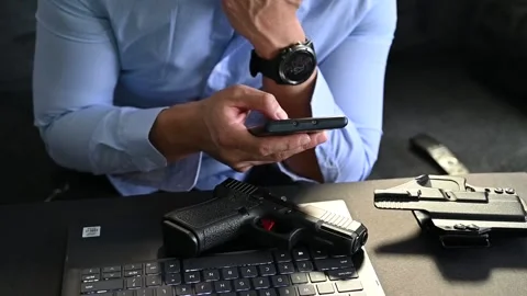 A secret agent with a loaded gun texting his partner Stock Footage 146287802