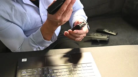 A secret agent loading his firearm in front of computer Stock Footage 146288571
