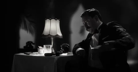 Secret agent loading his gun in an old fashion luxury hotel room Stock Footage 103235012