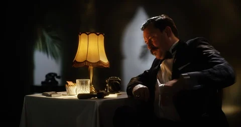 Secret agent loading his gun in an old fashion luxury hotel room Stock Footage 103235018