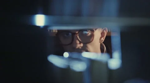 Secret agent looking for documents in the library Stock Footage 68606796