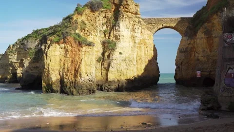 Secret beach with stone bridge over natural cliff formation Video stock 273675197