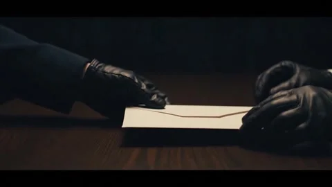 Secret Exchange: Gloved Hands Passing a Confidential Envelope Stock Footage 313246338