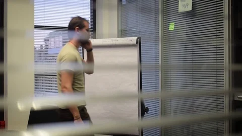 Secret insight through blinds where a man calling Stock Footage 71042142