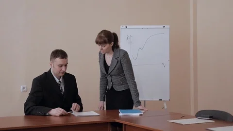 Secretary and director looking in documents at the table in business office Stock Footage 73822058