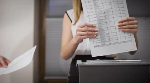 Secretary destroys documents using a special apparatus. Hiding confidential Video stock 62984250